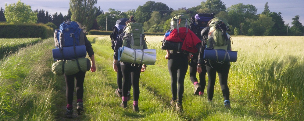 Group of Duke of Edinburgh participants on a hike wearing backpacks.