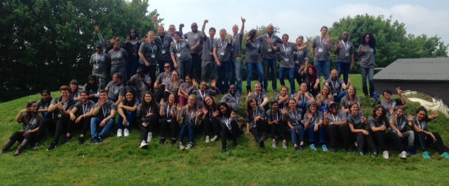 Large group of young people sat outdoors