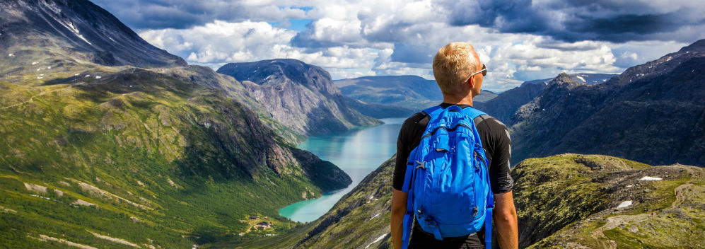 Man standing on a mountain looking at the view