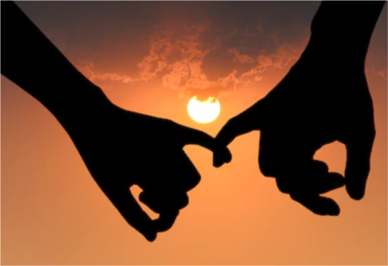 Two people hold each other's little finger in an affectionate embrace