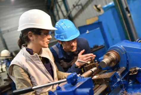 young people in hard hats in a engineering environment