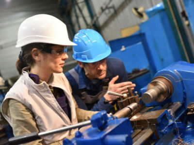 young people in hard hats in a engineering environment