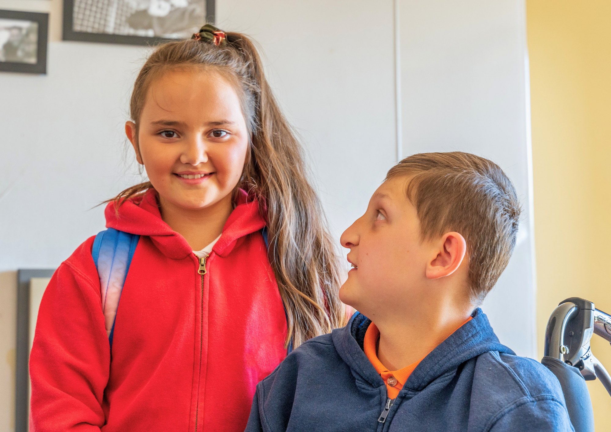 Two young siblings together indoors