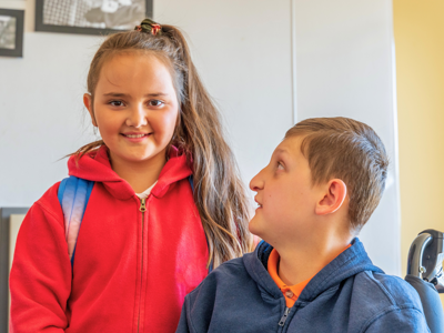 Two young siblings together indoors