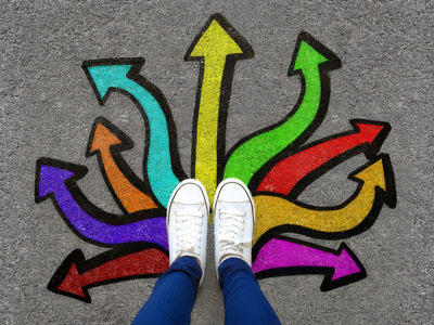 Person standing beside colourful direction arrows