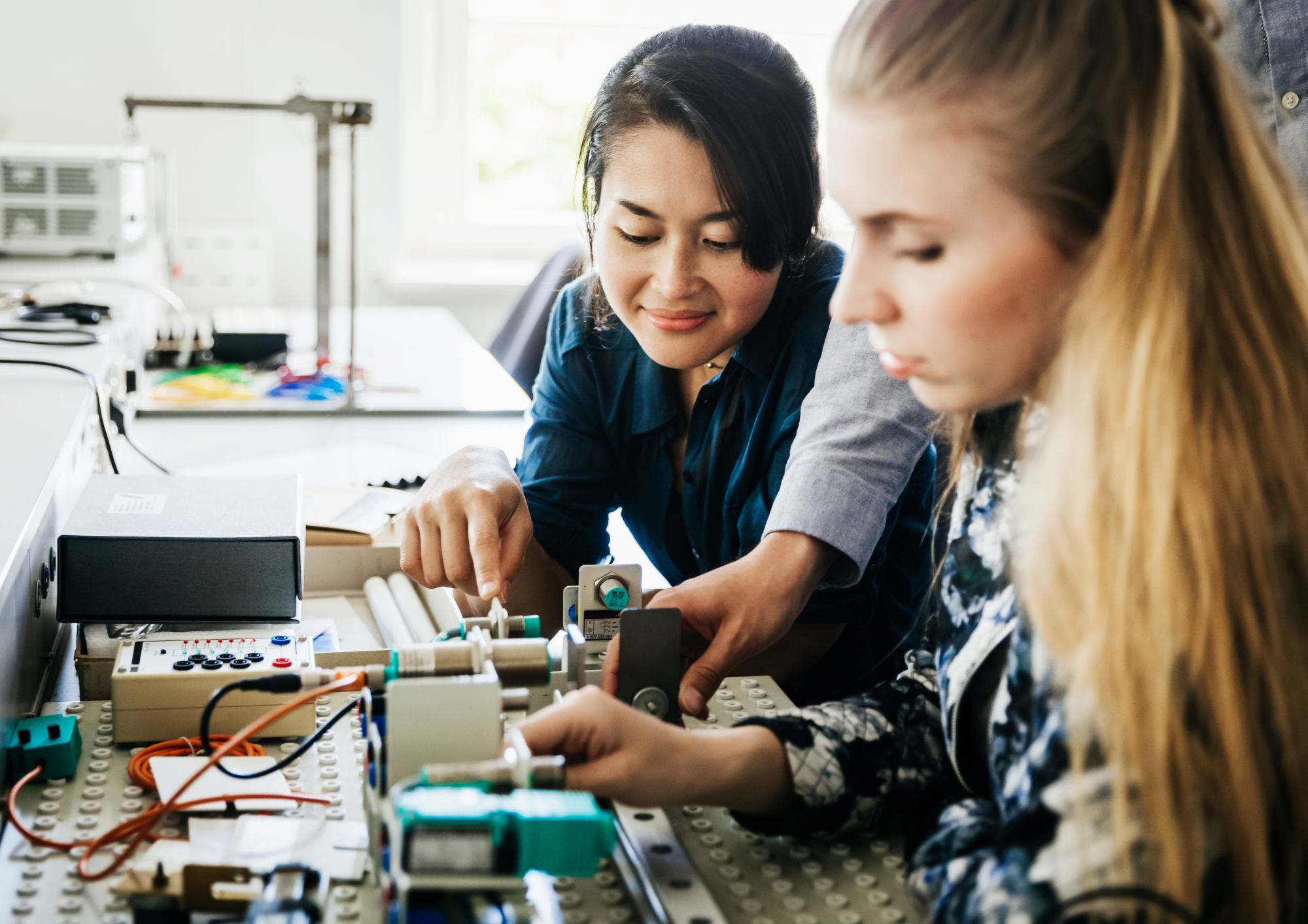 Young people working with engineering equipment