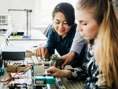 Young people working with engineering equipment