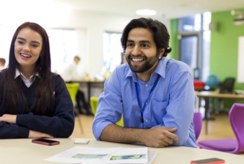 Teacher and student sitting at a table