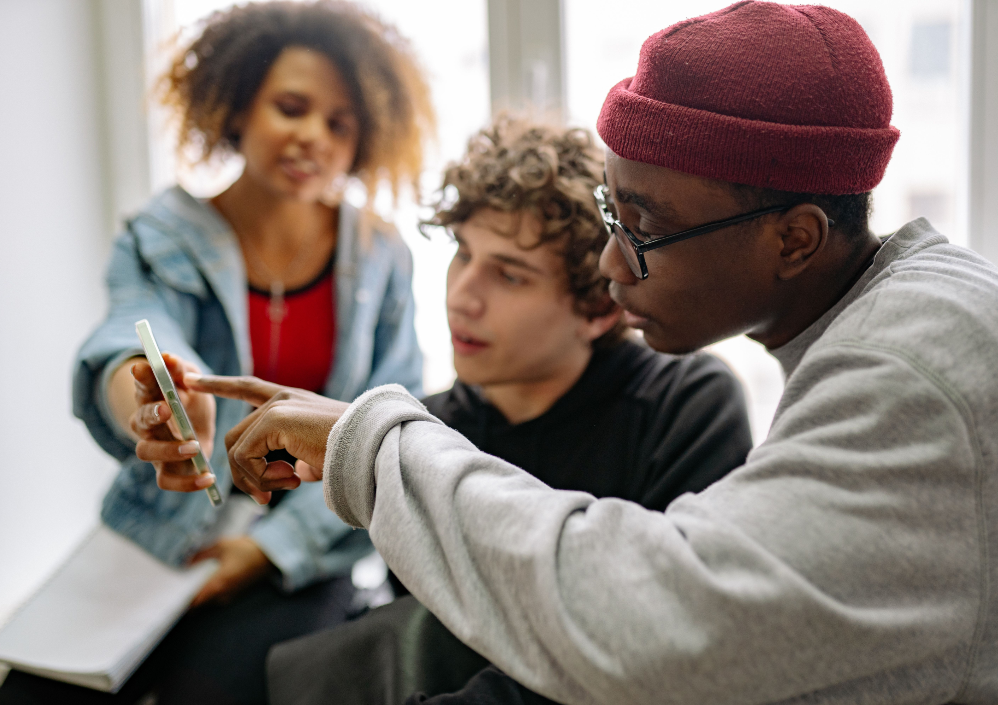 Young people looking at a smartphone together